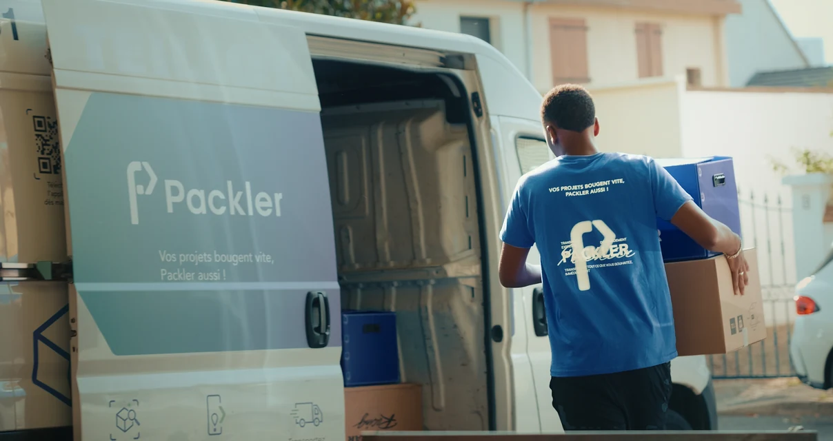 Déménageur Packler chargeant des cartons dans un utilitaire Packler